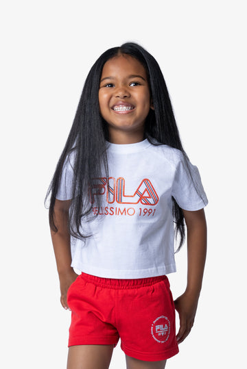 Child wearing a white t-shirt with red logo and red shorts on a white background